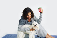 Model in Hygge cardigan smiling with dog