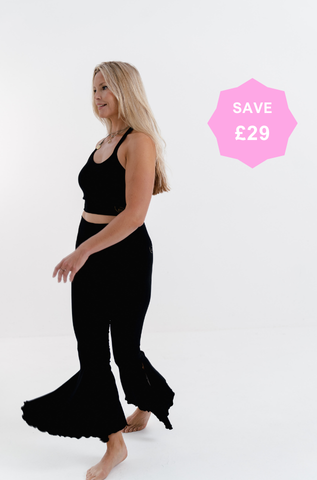 Go with the Flow matching set in black — halter neck crop top and flared leggings front view
