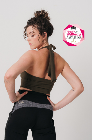 Model wearing olive green halter neck crop top, back view — long adjustable ties, open back