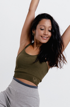 Model  wearing olive green halter neck yoga crop top, front view — seamless, removable pads, adjustable ties
