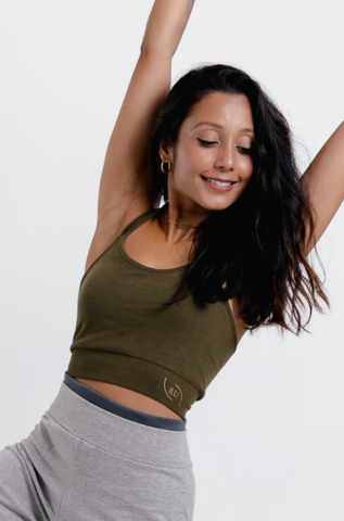 Model  wearing olive green halter neck yoga crop top, front view — seamless, removable pads, adjustable ties