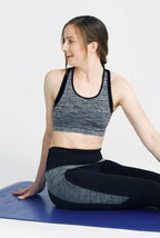 model doing yoga wearing Motivate Me Crop