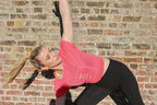 Model is wearing the Feel the Love logo T. Lightweight, coral colour, hip length, cap sleeves 