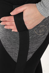 Close up image of Adaptive Dream Spin Leggings showing how to use  the adaptive feature tape to pull up leggings