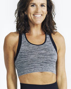 model smiling wearing Motivate Me Crop purple
