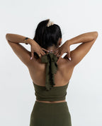 Zakiya back view ILU Go with the Flow Crop. Longer length, halter neck with adjustable ties.  Seamless, low impact. Removable pads 