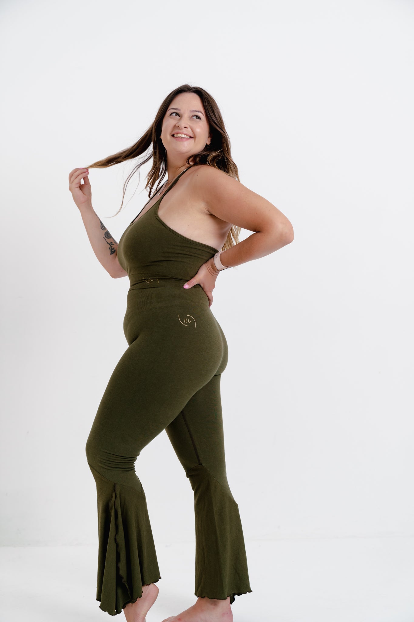 Ellen side view ILU Go with the Flow Crop. Longer length, halter neck with adjustable ties.  Seamless, low impact. Removable pads 