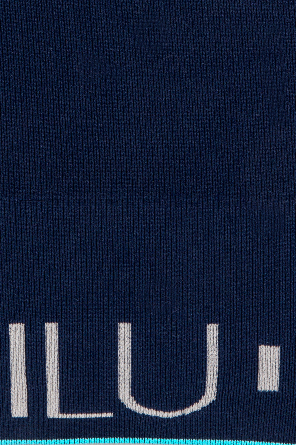 Motivate Me Vest hem band detail with sky blue accent and ILU branding — ILU Fitwear